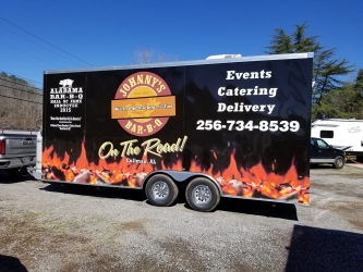 Wrapped food truck trailer colored orange and black from sign source