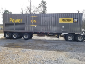 side view of Grey and yellow 52' trailer wrapped by sign source