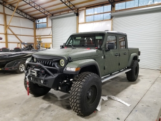 driver's side view of green wrapped jeep from sign source