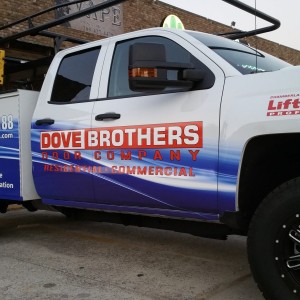 blue and white parked pickup truck for dove brothers