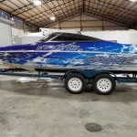 side of blue and white boat wrap titled "interceptor"