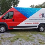 side of red and white vehicle wrapped afs van