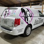 back of white van wrapped for air master with pink skunk logo