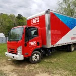 wrapped box truck with red and white pattern with blue water pattern